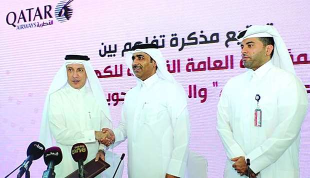 Kahramaa president Essa bin Hilal al-Kuwari and Qatar Airways Group chief executive Akbar al-Baker exchanging documents to ink the MoU as HIA COO Badr Mohamed al-Meer (right) looks on: PICTURE: Nasar T K.