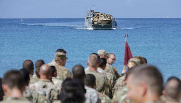 Soldiers from the 602nd Area Support Medical Company wait on a beach for a Navy landing craft as their unit evacuates in advance of Hurricane Maria, in Charlotte Amalie, St. Thomas, US Virgin Islands.