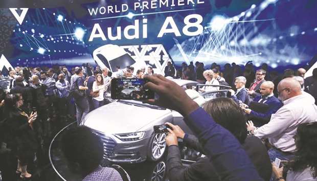 Attendees inspect an Audi A8 during a launch event in Barcelona on July 11. At the Frankfurt car show, Audi paraded the A8 which can drive itself under certain conditions, decide when to change lanes and does not require drivers to monitor the road u2014 though they must be ready to intervene at the sound of an alarm.