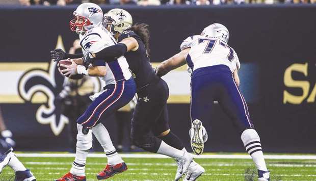 New Orleans Saints linebacker Hauu2019oli Kikaha (centre) sacks New England Patriots quarterback Tom Brady during the NFL game. (USA TODAY Sports)