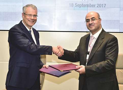 Dr Egon Toft and Jamal Saleh Hammad shake hands as they exchange the MoU.