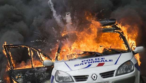 A police car as it explodes after being set on fire during an unauthorized counter-demonstration against police violence in Paris.