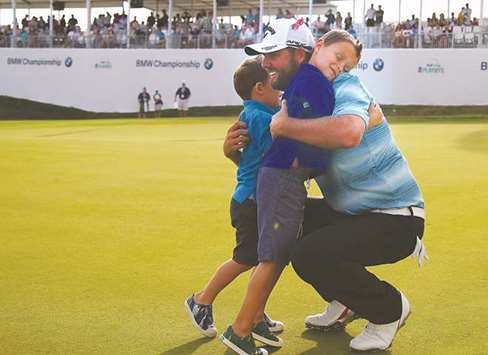 Marc Leishman of Australia celebrates with his two young sons Oliver and Harry after winning the BMW Championship at Conway Farms Golf Club on September 17, in  Lake Forest, Illinois.