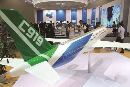 A model of C919 passenger jet by Commercial Aircraft Corp of China is displayed at Aviation Expo China 2017 in Beijing. COMAC yesterday signed 130 new orders for its C919 passenger jet with four Chinese leasing firms, after the plane took its maiden flight in May this year.