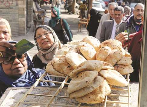 People buy bread at a bakery in Cairo (file). Egyptu2019s state grain buyer GASC received fewer offers and was quoted higher prices in a wheat tender yesterday, as traders held back due to a dispute over two blocked import cargoes.