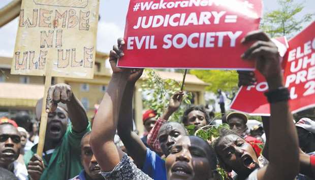 Supporters of President Uhuru Kenyatta-led Jubilee Alliance shout slogans during a demonstration outside the Supreme Court of Kenya in Nairobi yesterday.