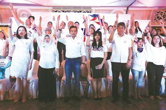 Senators Risa Hontiveros (left), Antonio Trillanes (third left), Francis Pangilinan (third right) and others raising a three-finger salute, as they launched the Tindig Pilipinas  (Arise Philippines) movement in Manila.