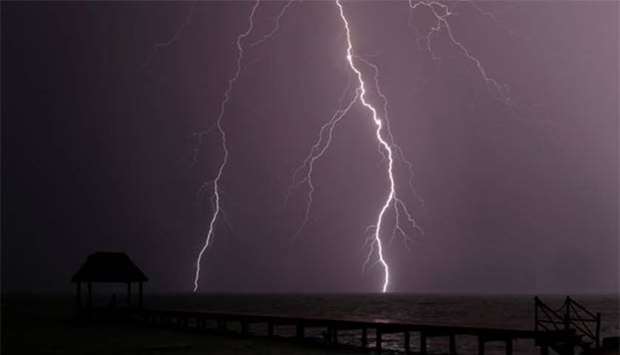 Lightning strikes the Caribbean as a thunderstorm passes Tankah Bay, near Tulum, southern Mexico.