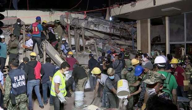 Rescue teams looking for people trapped in the rubble at the Enrique Rebsamen elementary school in Mexico City