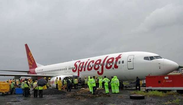 Aircraft recovery team members and airport officials inspect the SpiceJet plane that overshot the Mumbai runway. Picture: Plane Spotters India