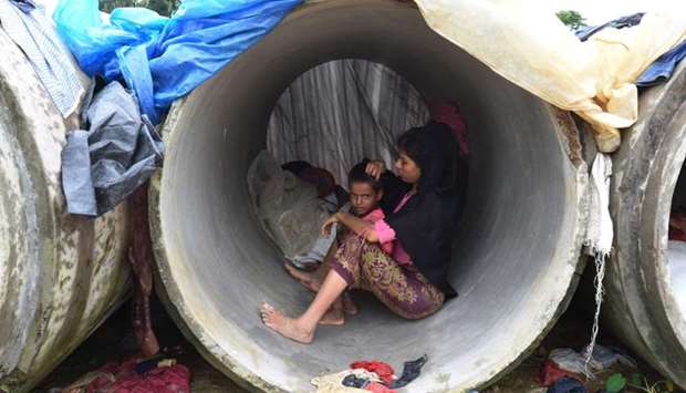 Rohingya Muslim refugees shelter in cement pipes at Kutupalong refugee camp in the Bangladeshi district of Ukhia