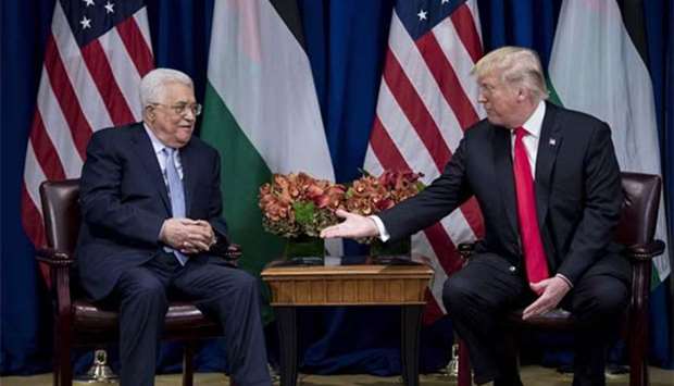US President Donald Trump reaches to shake Palestinian Authority President Mahmoud Abbas's hand before a meeting at the Palace Hotel during the 72nd United Nations General Assembly in New York on Wednesday.