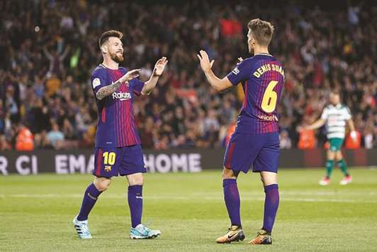 Barcelonau2019s midfielder from Spain Denis Suarez (right) celebrates with Barcelonau2019s forward from Argentina Lionel Messi after scoring during the Spanish league match against SD Eibar at the Camp Nou stadium in Barcelona yesterday. (AFP)