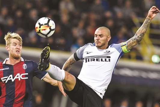 Inter Milanu2019s Mauro Icardi (R) fights for the ball with Bolognau2019s Filip Helander during the Seriea A match in Bologna. (AFP)