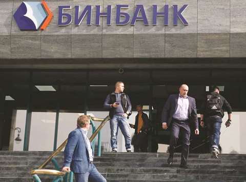 People gather outside the B&N Bank headquarters in central Moscow yesterday. B&N, the countryu2019s 12th biggest lender by assets, has sought a bailout from the central bank, just three weeks after another leading Russian bank had to be rescued.