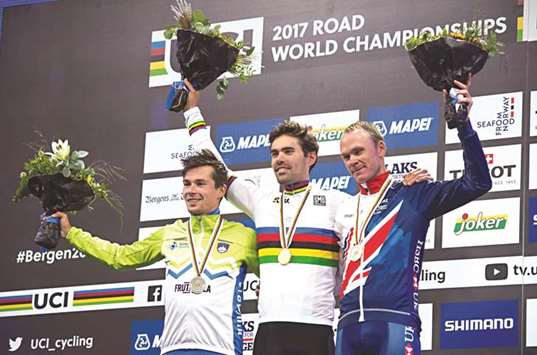 Silver medallist Primoz Roglic of Slovenia (left), gold medallist Tom Dumoulin of the Netherlands (centre) and bronze medallist Chris Froome of Britain celebrate on the UCI Road World Championships menu2019s time-trial podium in Bergen, Norway, yesterday. (Reuters)