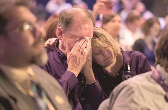 SWEEPING SENTIMENT: Cassini team members Colleen McGhee-French, right, and husband Richard French, left, shed tears as the Cassini mission to Saturn ends while watching on a screen at the Jet Propulsion Lab auditorium as the spacecraft burned up into the planetu2019s atmosphere in Pasadena, California.