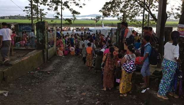 People displaced from communal violence boarding a boat at the Buthidaung jetty