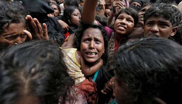 A woman reacts as Rohingya refugees wait to receive aid in Cox's Bazar, Bangladesh, on Thursday..