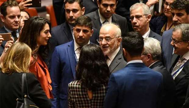 Amal Clooney (left) greets Iraq's Minister of Foreign affairs Ibrahim al-Jaafari at a Security Council meeting at UN headquarters during the United Nations General Assembly in New York on Thursday.