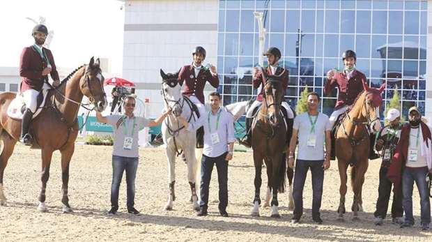 Qatar team, comprising Hamad al-Attiyah, Faleh al-Ajami, Salmen al-Suwaidi and Salman al-Emadi, celebrate on the podium after winning silver in the Equestrian Team Jumping event in Ashgabat yesterday. (Garsi Lotfi)