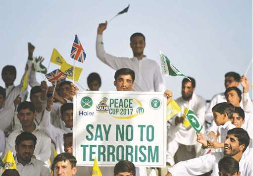 A Pakistani spectator carries a placard denouncing terrorism during a T20 cricket match between Pakistan XI and UK Media XI at the Younis Khan Cricket Stadium in Miranshah, the former stronghold of Al Qaeda and Taliban militants, in North Waziristan near the Afghan border.
