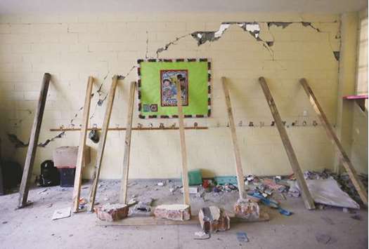 Support beams are seen placed on a crumbling wall of a room during the search for students at the Enrique Rebsamen school in Mexico City.