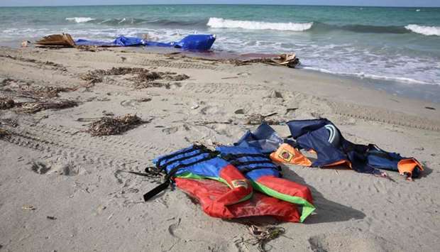 Life jackets are seen washed up on a beach yesterday after dozens of migrants drowned in a shipwreck off the coast of Sabrata.