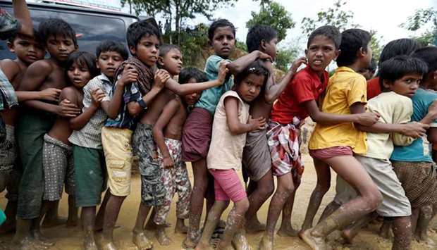 Rohingya refugee children queue for aid in Cox's Bazar, Bangladesh