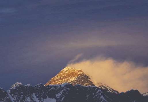 Light illuminates Mount Everest, during sunset in the Solukhumbu district also known as the Everest region.