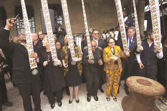 Cape Town mayor Patricia De Lille (third right), former archbishop Desmond Tutu and Western Cape Province Premier Helen Zille (third left) prepare to cut ribbons at the grand public opening of the Zeitz Museum of Contemporary African Art in Cape Town.