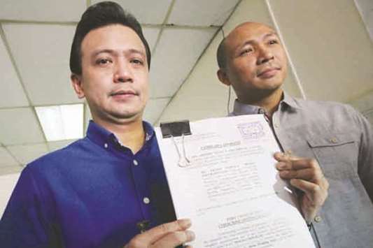 Senator Antonio Trillanes, accompanied by Magdalo party-list representative. Gary Alejano, shows his complaint against  Communications Assistant Secretary Mocha Uson before reporters at the Ombudsmanu2019s office yesterday.