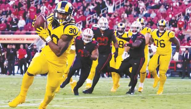 Los Angeles Ramsu2019 Todd Gurley (foreground) runs for a touchdown against the San Francisco 49ers during their NFL game at Leviu2019s Stadium in Santa Clara, California, on Thursday. (USA TODAY Sports)