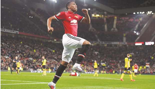 Manchester Unitedu2019s French striker Anthony Martial celebrates scoring his teamu2019s fourth goal during the English League Cup third round match against Burton Albion at Old Trafford in Manchester on September 20, 2017.  (AFP)