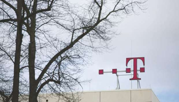 The T-Mobile logo is seen on top of the Deutsche Telekom headquarters in Bonn. Japanu2019s SoftBank Group Corp, which controls Sprint, will own 40 to 50% of the combined company, while T-Mobile majority owner Deutsche Telekom will own a majority stake, say sources.