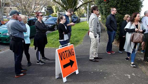 Voters wait outside a polling station at the St Heliers Tennis Club during the general election in Auckland
