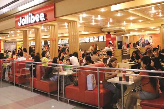Customers eat at a Jollibee fastfood outlet in Quezon City, Metro Manila.