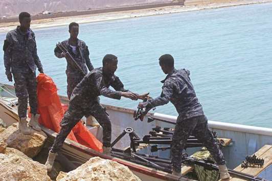 Somali Puntland forces receive weapons, seized from a boat on the shores of the Gulf of Aden, in the city of Bosasso.