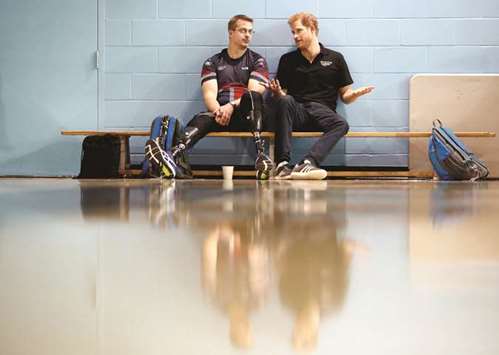Prince Harry speaks to an athlete at the Toronto Pan Am Sports Centre, ahead of the Invictus Games in Toronto.