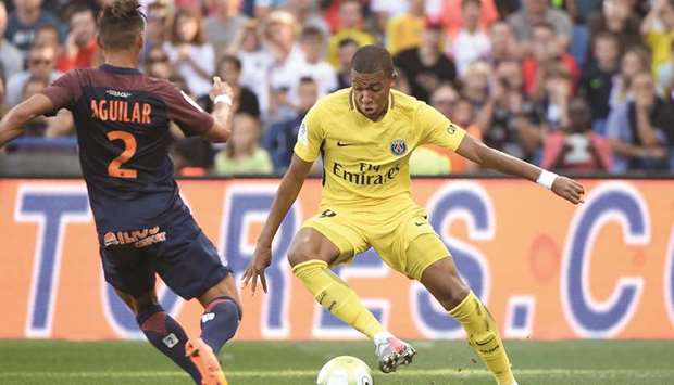 Paris Saint-Germainu2019s French forward Kylian Mbappe (right) dribbles Montpellieru2019s French defender Ruben Aguilar during the French Ligue 1 match in Montpellier. (AFP)
