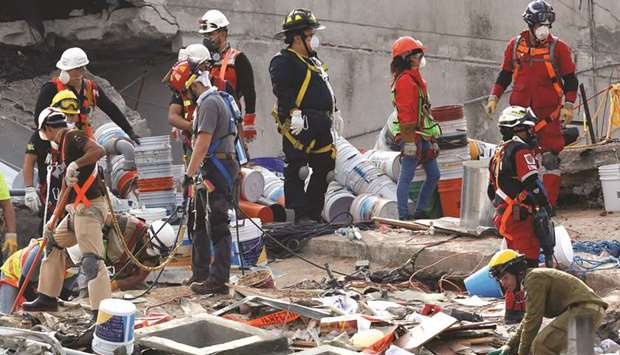 Mexican and international rescue teams search for survivors in a collapsed building in the Roma neighbourhood of Mexico City.
