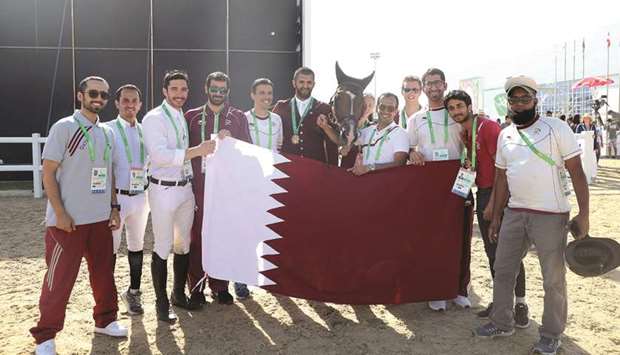 Qataru2019s Hamad al-Attiyah (centre) celebrates after winning the Individual Jumping gold at the Asian Indoor and Martial Arts Games yesterday.