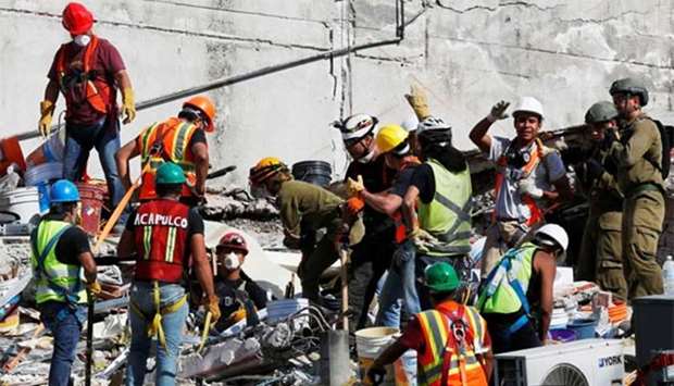 Mexican and international rescue teams search for survivors in a collapsed building after an earthquake in Mexico City, on Saturday.