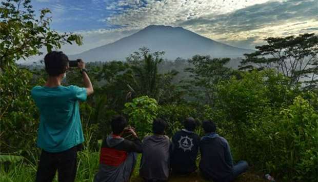 People look at Mount Agung in Karangasem on the Indonesian resort island of Bali on Sunday.