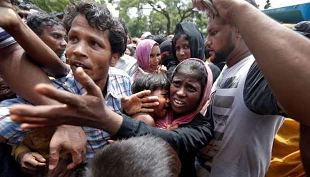 Rohingya refugees struggle to receive aid in Cox's Bazar on Saturday.