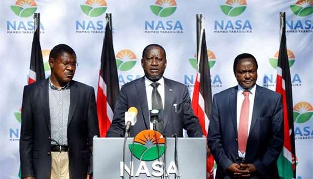 Kenyan opposition leader Raila Odinga (centre) and his running mate Kalonzo Musyoka (right) and Moses Wetangula attend a press conference in Nairobi on Friday.