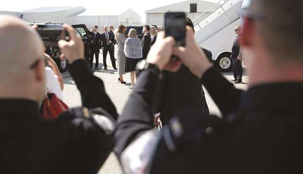 Law enforcement officers take mobile phone pictures after US First Lady Melania Trump arrived at Toronto Pearson International Airport for the opening ceremony of the Invictus Games.