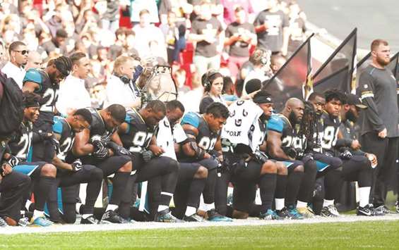 Jacksonville Jaguars players kneel in protest during the US national anthem before the NFL match against Baltimore Ravens at Wembley Stadium in London yesterday. (Reuters)