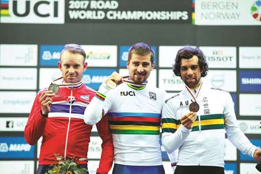 Gold medalist Peter Sagan (centre) of Slovakia, silver medalist Alexander Kristoff (left) of Norway and bronze medalist Michael Matthews of Australia pose on the podium after the Menu2019s Elite UCI Road World Championship race in Bergen, Norway, yesterday. (Reuters)