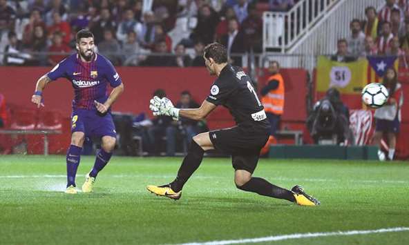 Barcelonau2019s Luis Suarez scores against Girona during the La Liga match in Estadi Montilivi, Girona, Spain on Saturday. (Reuters)